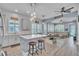 Open-concept kitchen with a breakfast bar, island seating, and seamless flow into the adjacent living room area at 8340 Laureate Blvd, Orlando, FL 32827