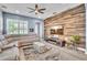 Comfortable living room with a sectional sofa, a decorative ottoman, and a stylish wood panel accent wall at 8340 Laureate Blvd, Orlando, FL 32827