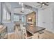 Living area with an entertainment center, a wood-paneled accent wall, and seamless flow into adjacent spaces at 8340 Laureate Blvd, Orlando, FL 32827