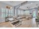 Open-concept living area featuring a kitchen island with bar stool seating and a dining table with bench seating at 8340 Laureate Blvd, Orlando, FL 32827