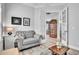 Cozy seating area with tufted chair and French doors that provide an open view of adjacent dining room at 8340 Laureate Blvd, Orlando, FL 32827