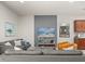 Cozy living room featuring modern furniture, an entertainment center, and a partial view of the kitchen at 8828 Bengal Ct, Kissimmee, FL 34747