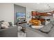 Open-concept living room featuring a modern kitchen, comfortable sofas, and entertainment setup at 8828 Bengal Ct, Kissimmee, FL 34747
