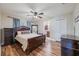 Warm bedroom features wood floors, elegant wood furniture, and a comfortable bed, creating a relaxing retreat at 1052 Dees Dr, Oviedo, FL 32765