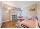 Comfortable bedroom with wood flooring, colorful rug, decor, a bay window and comfortable bed at 1052 Dees Dr, Oviedo, FL 32765