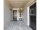 Covered front entry features tiled floor, gray walls, and a stylish black front door at 1052 Dees Dr, Oviedo, FL 32765