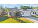 Charming single-story home with gray exterior, manicured lawn, and a two-car garage at 1052 Dees Dr, Oviedo, FL 32765
