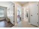 Bright hallway with multiple rooms, neutral paint and trim, with wood look flooring in some areas at 1052 Dees Dr, Oviedo, FL 32765