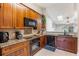Well-lit kitchen features wood cabinets, granite countertops, and stainless steel appliances at 1052 Dees Dr, Oviedo, FL 32765