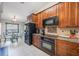 Well-equipped kitchen with wooden cabinetry, granite countertops, and modern appliances at 1052 Dees Dr, Oviedo, FL 32765