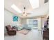 Bright living room with skylights, tile flooring, and sliding glass doors to the lanai at 1052 Dees Dr, Oviedo, FL 32765