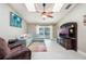 Cozy living room with lots of natural light, a modern ceiling fan, and tile flooring at 1052 Dees Dr, Oviedo, FL 32765