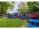 Community playground with slides, swings, climbing structures, and picnic tables surrounded by lush greenery at 1052 Dees Dr, Oviedo, FL 32765