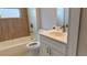 Bright bathroom features a shower-tub combination and a vanity with modern fixtures at 13329 Sw 48Th Ave, Ocala, FL 34473