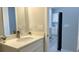 Bathroom with vanity, white cabinets, quartz countertop, and modern faucet at 13329 Sw 48Th Ave, Ocala, FL 34473