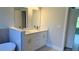 Modern bathroom with double vanity, quartz countertop, white cabinets, and tile accents at 13329 Sw 48Th Ave, Ocala, FL 34473