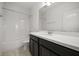 Bright bathroom featuring a combination tub and shower with white tile surround and a dark vanity with white countertop at 14154 Shocklach Dr, Winter Garden, FL 34787