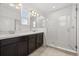Bright bathroom features a dual vanity, glass-enclosed shower, and tile flooring at 14154 Shocklach Dr, Winter Garden, FL 34787