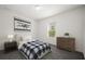 Bedroom with a large window, wooden dresser, white walls, and carpeted floors at 14154 Shocklach Dr, Winter Garden, FL 34787