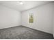 Neutral bedroom with carpeting, a single window, and plain white walls at 14154 Shocklach Dr, Winter Garden, FL 34787