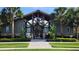 Elegant clubhouse with detailed architecture, palm trees, and gated entrance at 14154 Shocklach Dr, Winter Garden, FL 34787