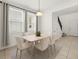 Bright dining room features a modern table with six chairs beneath a pendant light fixture at 14154 Shocklach Dr, Winter Garden, FL 34787