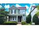 Charming two-story home featuring a covered porch, landscaped yard, and a beautifully painted exterior at 14154 Shocklach Dr, Winter Garden, FL 34787