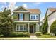 Charming two-story home with green exterior, brown shutters, manicured lawn, and inviting front porch at 14154 Shocklach Dr, Winter Garden, FL 34787