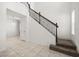 Foyer features tile flooring, staircase with dark wood banister, and white walls at 14154 Shocklach Dr, Winter Garden, FL 34787