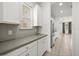 Modern kitchen with gray backsplash, white cabinetry, stainless steel appliances, and sleek countertops at 14154 Shocklach Dr, Winter Garden, FL 34787