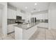 Modern kitchen with stainless steel appliances, gray backsplash, spacious island, and ample white cabinetry at 14154 Shocklach Dr, Winter Garden, FL 34787