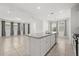 Bright, open kitchen with spacious island and stainless steel appliances seamlessly connects to the living areas at 14154 Shocklach Dr, Winter Garden, FL 34787