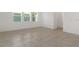 Bright and open living room featuring tile flooring and large windows offering ample natural light at 14154 Shocklach Dr, Winter Garden, FL 34787