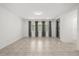 Empty living room featuring gray curtains, tile flooring, a stainless steel framed mirror, and bright light at 14154 Shocklach Dr, Winter Garden, FL 34787
