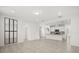 Open living space with tile flooring, white walls, stainless steel framed mirror, and direct access to kitchen at 14154 Shocklach Dr, Winter Garden, FL 34787