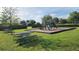 Community playground features a slide, climbing area, and picnic tables at 14154 Shocklach Dr, Winter Garden, FL 34787