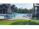 Community pool features a covered clubhouse, lounge chairs, tables, and umbrellas at 14154 Shocklach Dr, Winter Garden, FL 34787