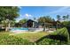 Enjoy the community pool with lounge chairs, tables, umbrellas, and pergola at 14154 Shocklach Dr, Winter Garden, FL 34787