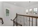 Bright stairway with wooden railing, white walls, and natural light from multiple windows at 14154 Shocklach Dr, Winter Garden, FL 34787