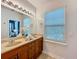 Bathroom with double vanity, wood cabinets, and large mirror at 2240 Osprey Ave, Orlando, FL 32814