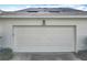 A well-maintained garage door with house number and trimmed landscape on a sunny day at 2240 Osprey Ave, Orlando, FL 32814