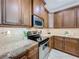 Well-equipped kitchen with granite countertops, stainless appliances, and tile backsplash at 2240 Osprey Ave, Orlando, FL 32814