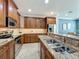 Modern kitchen with stainless steel appliances, granite countertops, and ample cabinetry at 2240 Osprey Ave, Orlando, FL 32814