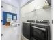 Modern laundry room with a gray washer and dryer and shelving at 2240 Osprey Ave, Orlando, FL 32814