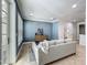 Bright living room features tile flooring, recessed lighting, a gray accent wall, and access to the bathroom at 2240 Osprey Ave, Orlando, FL 32814