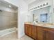The main bathroom features dual sinks and a shower with glass door at 2240 Osprey Ave, Orlando, FL 32814