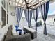 Inviting outdoor patio with seating and stylish striped curtains at 2240 Osprey Ave, Orlando, FL 32814