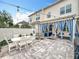 Charming patio with dining table, seating, hot tub, and blue striped curtains for an inviting outdoor space at 2240 Osprey Ave, Orlando, FL 32814