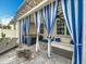 Outdoor patio with a hot tub, striped curtains, and lounge chairs at 2240 Osprey Ave, Orlando, FL 32814