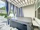 Backyard patio featuring a hot tub, striped curtains, and pavers at 2240 Osprey Ave, Orlando, FL 32814